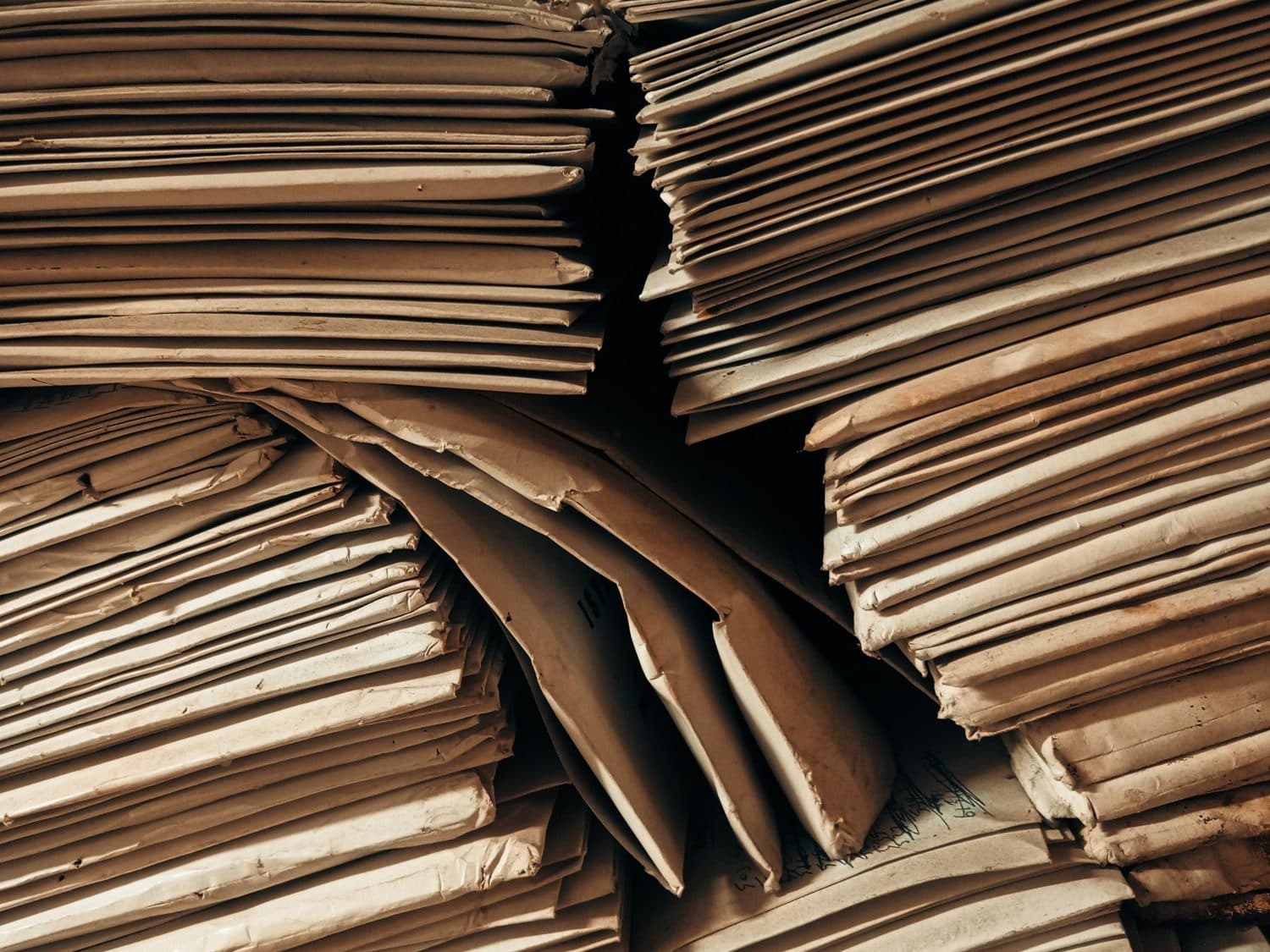 Stacks of paper files, bound and shelved